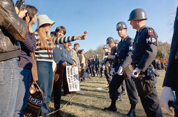 A protestor offers a flower to police during an anti-Vietnam War demonstration at the Pentagon in October 1967. 